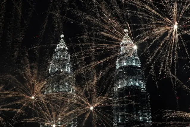 Fireworks explode near Petronas Twin Towers during New Year celebrations in Kuala Lumpur, Malaysia on January 1, 2020. (Photo by Lim Huey Teng/Reuters)