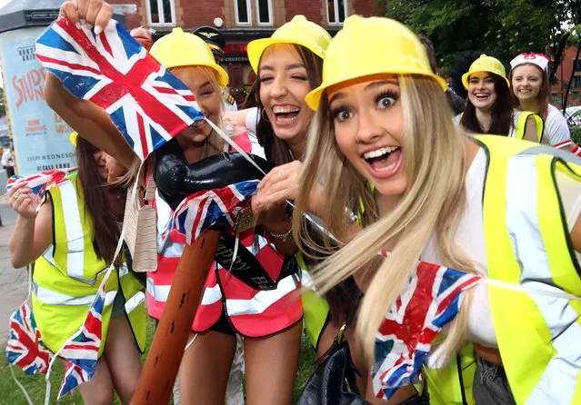 These friends enjoying a night out in the West Yorkshire city beamed for the cameras as they waved Union flags during the Queen Elizabeth II's platinum jubilee celebrations on June 4, 2022. (Photo by Nb press ltd)