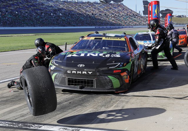 Tyler Reddick (45) has his tires changed on pit road during a NASCAR Cup Series auto race at Kansas Speedway in Kansas City, Kan., Sunday, September 29, 2024. (Photo by Colin E. Braley/AP Photo)