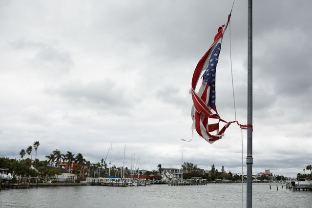 A torn American flag weaves in the aftermath of Hurricane Helene and before the arrival of Hurricane Milton, St. Pete Beach, Florida, U.S., October 7, 2024. (Photo by Octavio Jones/Reuters)