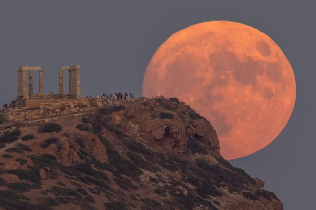 A full moon known as the “Blue Moon” rises behind the Temple of Poseidon, in Cape Sounion, near Athens, Greece on August 30, 2023. (Photo by Stelios Misinas/Reuters)