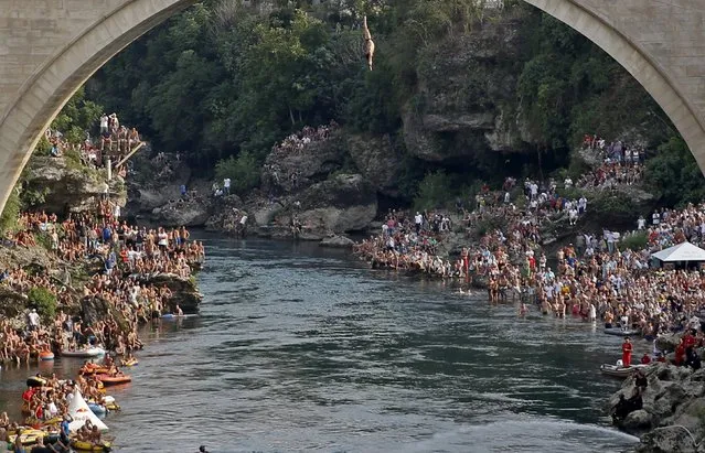 A competitor jumps from the Old Bridge during Red Bull Cliff Diving Competition in Mostar, Bosnia and Herzegovina on August 15, 2015. (Photo by Dado Ruvic/Reuters)