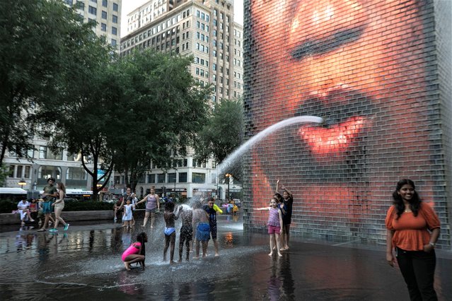 Children cool down at Crown Fountain in downtown Chicago, the United States on August 23, 2023. The temperature at O'Hare International Airport in Chicago, the third most populous city in the United States, reached 98 degrees Fahrenheit (36.67 degrees Celsius) Wednesday afternoon, breaking the city's previous daily high temperature record for Aug. 23 of 97 degrees Fahrenheit (36.11 degrees Celsius), according to the U.S. National Weather Service. The previous record for Aug. 23 was set in 1947, Chicago Sun Times reported on Wednesday. (Photo by Xinhua News Agency/Rex Features/Shutterstock)