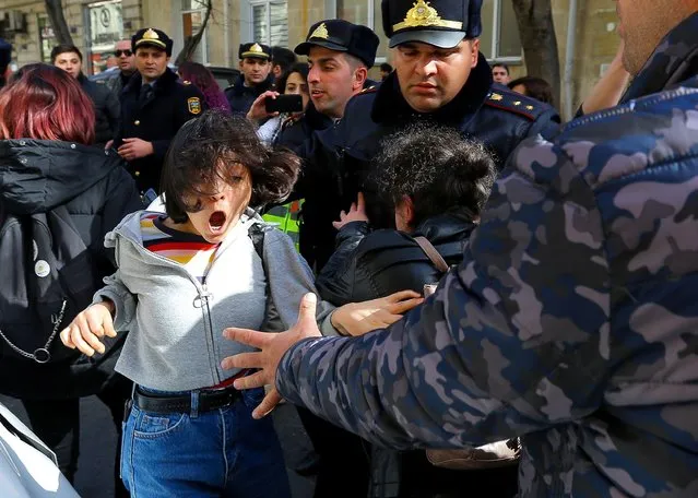 Law enforcement officers block activists during a rally held to support women's rights and to protest against violence towards women on International Women's Day in Baku, Azerbaijan on March 8, 2020. (Photo by Aziz Karimov/Reuters)