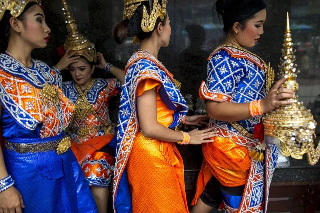 Thai classical dancers prepare their costumes before performing at the Erawan shrine, the site of last Monday's deadly blast, in Bangkok, Thailand, August 24, 2015. (Photo by Athit Perawongmetha/Reuters)