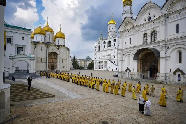 In this handout photo released by Russian Orthodox Church Press Service, Russian Orthodox Church priests walk to attend a religion service in the Kremlin's Assumption Cathedral marking the 1,034th anniversary of the adoption of Christianity by Prince Vladimir, the leader of Kyivan Rus, a loose federation of Slavic tribes that preceded the Russian state in Moscow, Russia, Thursday, July 28, 2022. (Photo by Igor Palkin, Russian Orthodox Church Press Service via AP Photo)