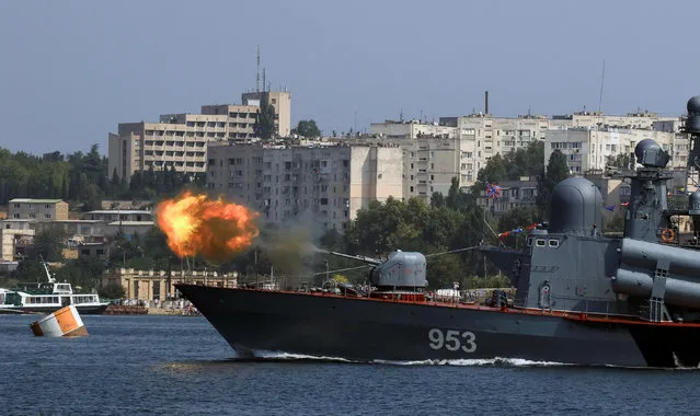 A missile corvette fires during the Navy Day celebrations in Sevastopol, Crimea, July 31, 2016. (Photo by Pavel Rebrov/Reuters)