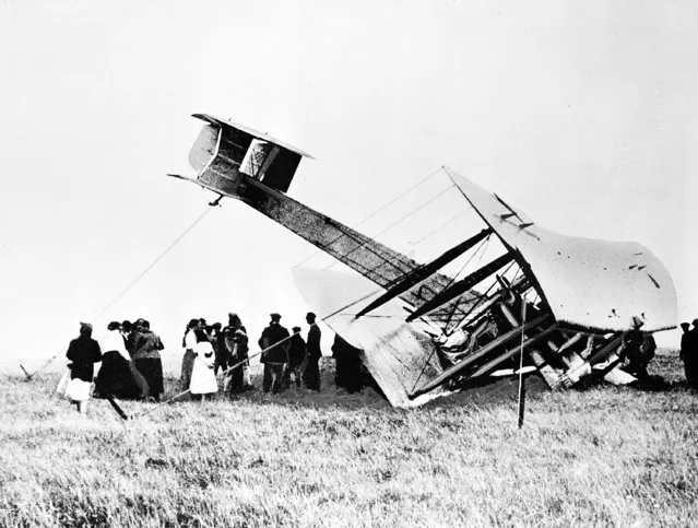Aviation pioneers John Alcock and Arthur Whitten Brown crash-land their Vickers Vimy aircraft in a bog near the wireless station at Clifden, Ireland, on June 15, 1919, after they complete the first nonstop transatlantic flight from St. Johns, Newfoundland, to the Irish coast. (Photo by AP Photo)
