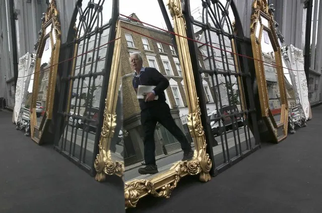 A man is reflected as he passes a mirror store in London, Britain June 18, 2016. (Photo by Neil Hall/Reuters)