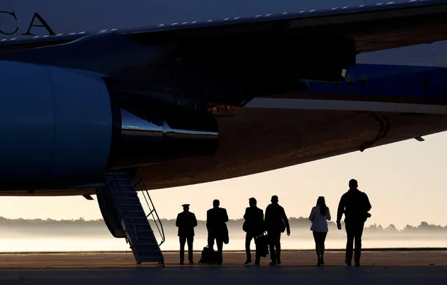On a misty morning, members of the White House press corps board Air Force One at Joint Base Andrews in Maryland, U.S., on their way to Las Vegas with U.S. President Donald Trump October 4, 2017. (Photo by Kevin Lamarque/Reuters)