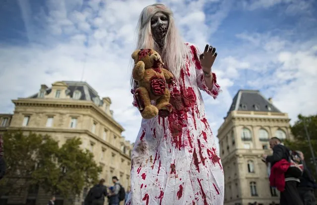 Participants in costume take part in a walk for World Zombie Day 2017, on Place de la Republique in Paris, France, 07 October 2017. (Photo by Ian Langsdon/EPA/EFE)