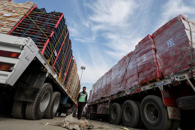 A truck driver walks near trucks carrying humanitarian aid as he waits to cross into the Gaza Strip at the Rafah border crossing, amid a ceasefire between Israel and Hamas, in Rafah, Egypt on January 28, 2025. (Photo by Amr Abdallah Dalsh/Reuters)