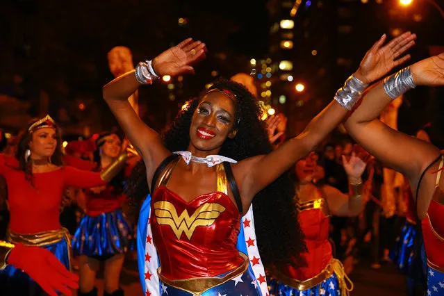 A group of ladies dressed as Wonder Woman dance in the streets at the 44th annual Village Halloween Parade in New York City on Tuesday, October 31, 2017. (Photo by Gordon Donovan/Yahoo News)