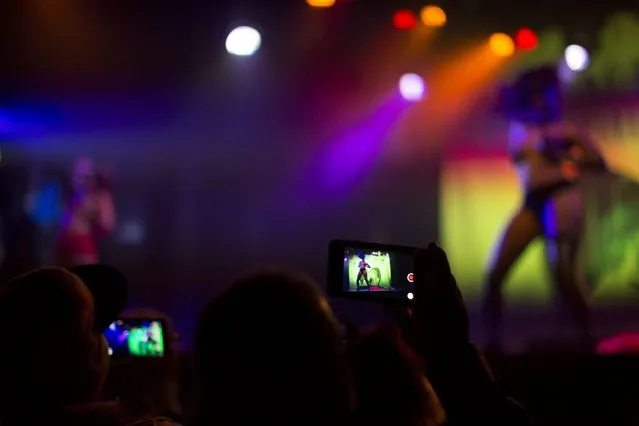 Members of the audience use their mobile devices during the Blackheart Burlesque show by the “Suicide Girls” at El Rey theatre in Los Angeles, California September 12, 2015. (Photo by Mario Anzuoni/Reuters)