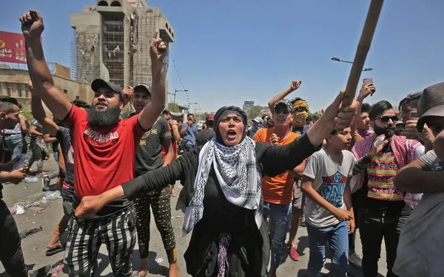 A woman shouts slogans as she takes part with Iraqi protesters in an an anti-government demonstration on Al-Jumhuriyah bridge in the capital Baghdad, on May 10, 2020. Modest anti-government rallies resumed in some Iraqi cities today, clashing with security forces and ending months of relative calm just days after Prime Minister Mustafa Kadhemi's government came to power. (Photo by Ahmad al-Rubaye/AFP Photo)