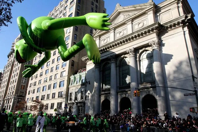 The Kermit the Frog balloon makes it's way down New York's Central Park West during the 86th Annual Macy's Thanksgiving Day Parade. (Photo by Tina Fineberg/Associated Press)