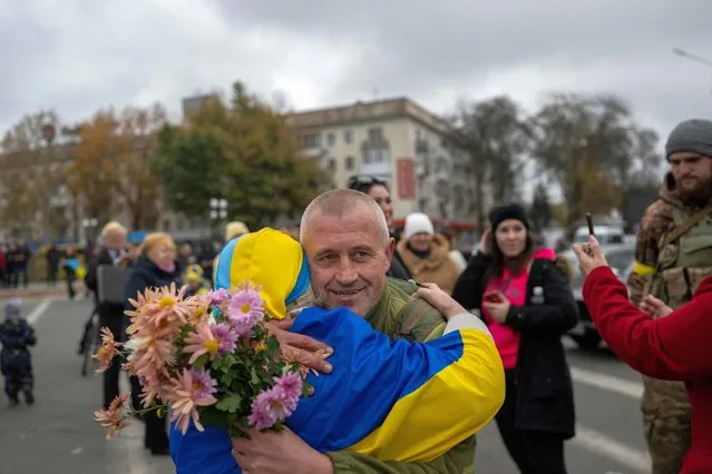 A woman hugs a Ukrainian soldier as local residents celebrate the liberation of their town in Kherson, on November 13, 2022, amid Russia's invasion of Ukraine. - Ukrainians in the liberated southern city of Kherson expressed a sense of relief on November 11, 2022, after months of Russian occupation. There were no scenes of jubilation on November 13, 2022, an AFP correspondent said, but many locals said they felt a great sense of relief after Kyiv had wrested back control of the city. (Photo by AFP Photo/Stringer)
