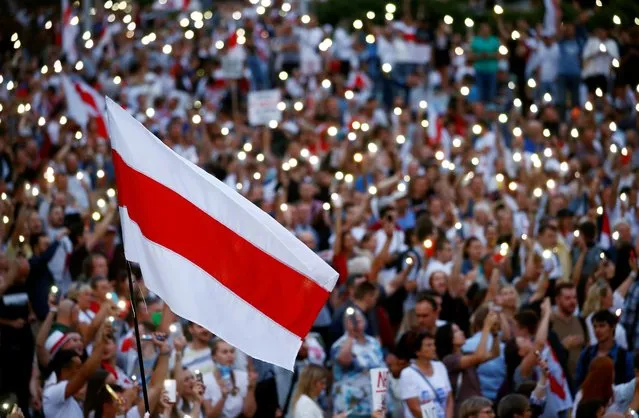 A historical white-red-white flag of Belarus is seen as people attend an opposition demonstration in Minsk, Belarus on August 18, 2020. (Photo by Vasily Fedosenko/Reuters)