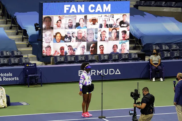 Naomi Osaka, of Japan, wears a mask in honor of Breonna Taylor as she speaks in front of a video display of fans before facing Misaki Doi, of Japan, during the first round of the US Open tennis championships, Monday, August 31, 2020, in New York. (Photo by Frank Franklin II/AP Photo)