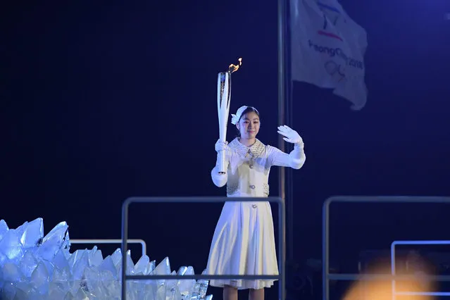 South Korean figure skater Kim Yu-na prepares to light the cauldron with the Olympic Flame during the opening ceremony of the Pyeongchang 2018 Winter Olympic Games at the Pyeongchang Stadium on February 9, 2018. (Photo by Mohd Rasfan/AFP Photo)