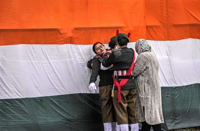 Cadets of the National Cadet Corps (NCC) attend to a unconscious who fainted after a Republic Day parade in Srinagar, Indian controlled Kashmir, Thursday, January 26 , 2023. (Photo by Mukhtar Khan/AP Photo)