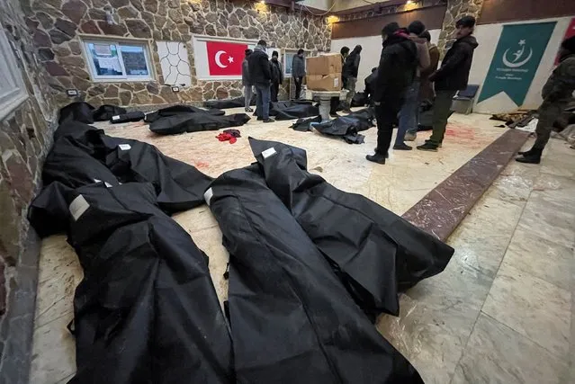Dead bodies in bags lie on the floor in a hospital, following an earthquake, in Afrin, Syria on February 6, 2023. (Photo by Mahmoud Hassano/Reuters)