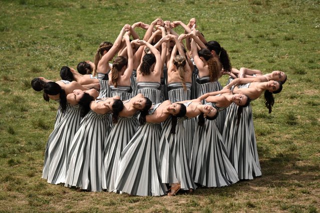 Actresses perform during the Olympic flame lighting ceremony for the Paris 2024 Olympics Games at the Ancient Olympia archeological site, birthplace of the ancient Olympics in southern Greece, on April 16, 2024. (Photo by Angelos Tzortzinis/AFP Photo)