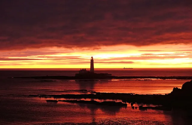 The sun rises behind St Mary's lighthouse in Whitley Bay, Tyne and Wear, England on December 20, 2017. (Photo by Owen Humphreys/PA Images via Getty Images)