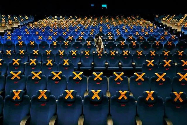 Staff member marks seats for social distancing at a movie theatre at CGV cinema amid the COVID-19 pandemic in Jakarta, Indonesia, October 21, 2020. (Photo by Ajeng Dinar Ulfiana/Reuters)