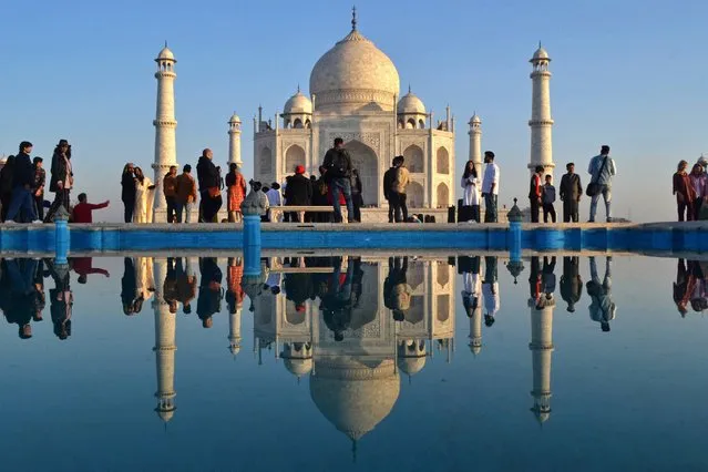 Tourists visit the Taj Mahal during early morning in Agra on February 15, 2023. (Photo by Pawan Sharma/AFP Photo)