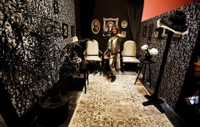 A guest takes a selfie in a antique-style black and white room during a VIP preview ahead of the opening of The Museum of Selfies in Glendale, California, U.S., March 29, 2018. The museum, which is set in a former department store, includes a timeline of the selfie from the first cave painting to Facebook and mobile phone cameras. (Photo by Mario Anzuoni/Reuters)