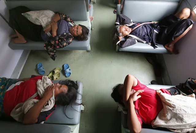 Passengers sleep in a train bound for north province of Chiang Mai at Hua Lampong railway station in Bangkok, Thailand, Wednesday, July 26, 2017. Hua Lampong is the main railway station in the country. (Photo by Sakchai Lalit/AP Photo)