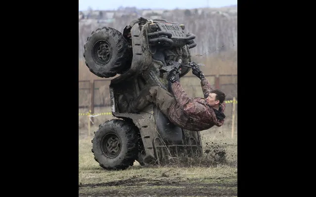 A rider performs before the “Kings of the Off-road” quad bike amateur regional race in a Siberian boggy district near the village of Kozhany, some 200 km (124 miles) southwest of Krasnoyarsk, Russia, on May 2, 2013. (Photo by Ilya Naymushin/Reuters)