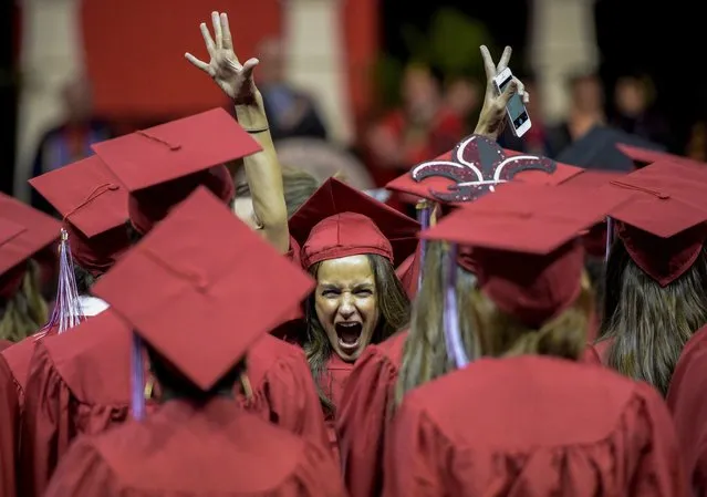 Simone Ancelet, a graduate in the College of General Studies at the University of Louisiana at Lafayette, raises her hands in excitement following the university's fall commencement general assembly at the Cajundome in Lafayette, La., Friday, December 19, 2014. (Photo by Paul Kieu/AP Photo/The Daily Advertiser)