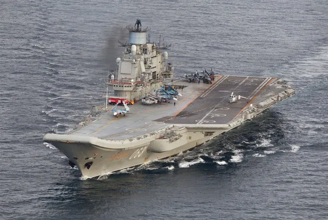 This October 17, 2016 Norwegian Armed Forces handout image shows the Russian aircraft carrier Admiral Kuznetsov passing the Norwegian island of Andoya in international waters on its way to the mediterranean. The Admiral Kuznetsov aircraft carrier the nuclear powered battleship Pyotr Velikiy and six other vessels were photographed by Norway' s Lockheed P-3 Orion surveillance aircraft. (Photo by AFP Photo/Forsvaret)