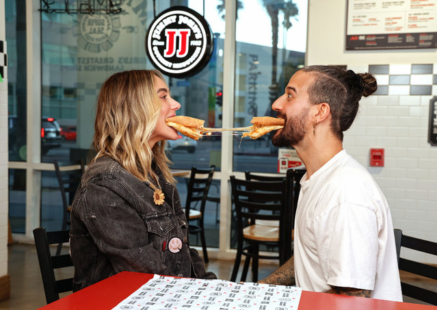 “Dancing with the Stars” Pro Mark Ballas and wife BC Jean share a perfectly cheesy moment with a Jimmy John’s Toasted Pizza Sandwich ahead of tonight’s episode on October 7, 2025. (Photo by Sara Jaye Weiss)
