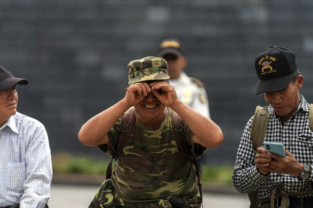 A civil war veteran jokingly reacts to the camera as he joins other former soldiers at a protest in Guatemala City, Wednesday, June 26, 2024. Former soldiers across the country are demanding the Guatemalan government issue them a war-time money bonus for serving in Guatemala's 1960-1996 civil war. (Photo by Moises Castillo/AP Photo)