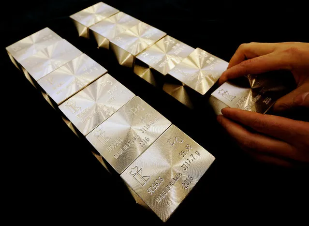 An employee places ingots of 99.98 percent pure palladium on a table at the Krastsvetmet non-ferrous metals plant, one of the world's largest producers in the precious metals industry, in the Siberian city of Krasnoyarsk, Russia October 24, 2016. (Photo by Ilya Naymushin/Reuters)