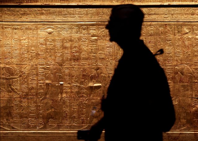 A man walks past one of the shrines of ancient Egyptian king Tutankhamun during the first day for visitors, after the official opening of the Grand Egyptian Museum (GEM), near the Giza pyramid complex, in Giza, Egypt, on November 4, 2025. (Photo by Mohamed Abd El Ghany/Reuters)