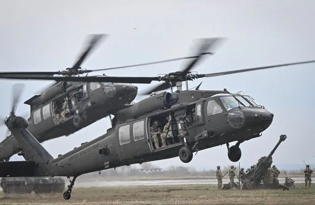 Two Black Hawk helicopters take off during a demonstration as part of the rotation of US troops of the US Army 101 Airborne division at Mihail Kogalniceanu Air Base (RoAF 57th Air Base) near Constanta, Romania on March 31, 2023. The positioning of 101 Airborne's army combat brigade in Romania is part of an enhanced military presence along NATO's eastern flank that has taken root in the aftermath of Russia's war on Ukraine, on a mission aimed at deterring potential aggression on NATO's southeastern flank. (Photo by Daniel Mihailescu/AFP Photo)