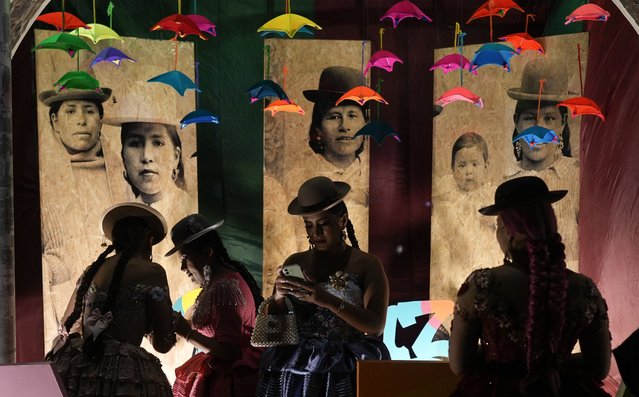 Women prepare to model creations by a local designer at a Chola fashion show, promoting the Andean style and beauty of Aymara women, in La Paz, Bolivia, Friday, October 18, 2024.  (Photo by Juan Karita/AP Photo)