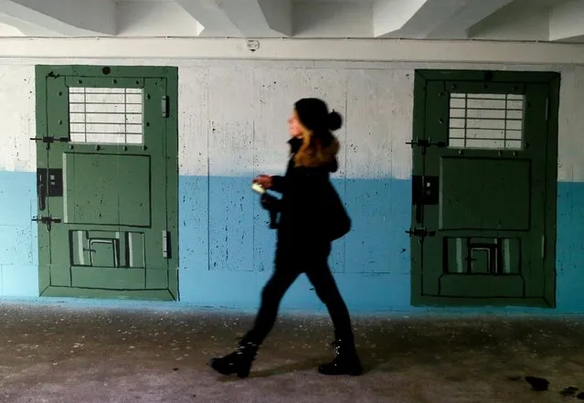 A pedestrian walks in an underpass painted to look like a prison corridor in central Kyiv, Ukraine on February 2, 2021. Georgian artist David Kukhalashvili created the art project “Underground Despair”, dedicated to 98 Crimean residents who were arrested after the annexation of the peninsula by Russia. (Photo by Gleb Garanich/Reuters)