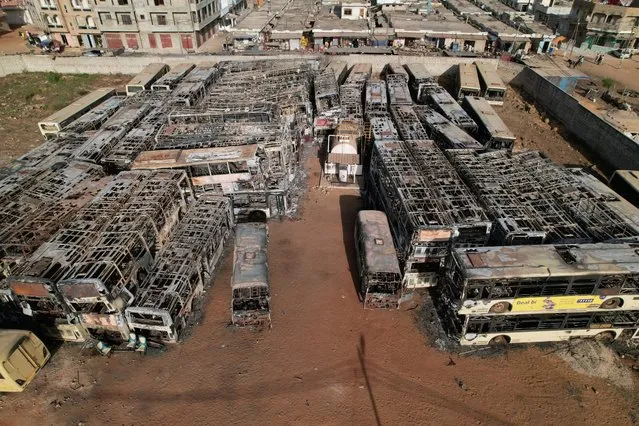 Burnt-out buses which belong to a partly state-funded “Dem Dikk” company, that provides intercity, national and regional bus services, are seen following violent protests after Senegal opposition leader Ousmane Sonko was sentenced to prison, in Keur Massar neighborhood, Dakar, Senegal on June 7, 2023. (Photo by Ngouda Dione/Reuters)