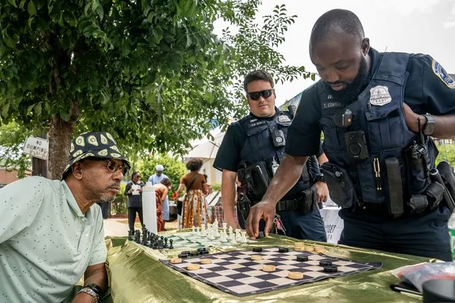 Metropolitan Police Officer Thomas Conteh (R) plays checkers against an attendee of a neighborhood Juneteenth festival on June 17, 2023 in Washington, DC. Two years ago, President Joe Biden signed bipartisan legislation establishing Juneteenth as a federal holiday. Juneteenth commemorates the day on June 19, 1865 when a Union general read orders in Galveston, Texas stating all enslaved people in the state were free according to federal law. (Photo by Nathan Howard/Getty Images)