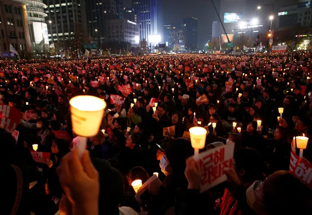 Protesters carrying lit candles shout slogans at a protest calling South Korean President Park Geun-hye to step down, in Seoul, South Korea, November 19, 2016. (Photo by Kim Hong-Ji/Reuters)