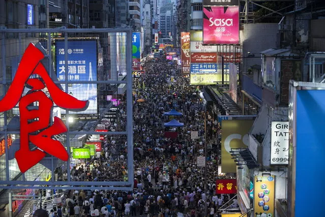 Thousands of people gathering to see buskers performances in Sai Yeung Choi Street South in Mongkok district, Hong Kong, China, 29 July 2018. (Photo by Jerome Favre/EPA/EFE)