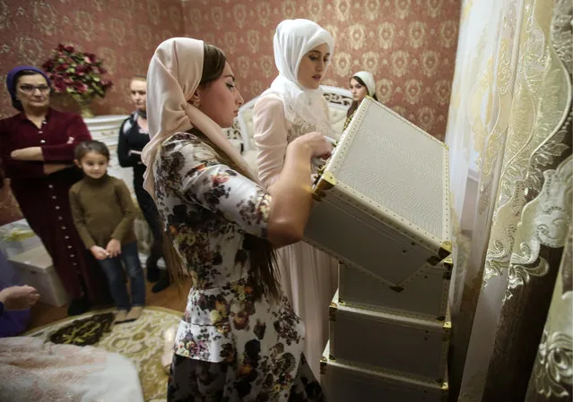 Relatives and family members with suitcases of the bride' s dowry on the day of wedding in Chechen capital Grozny, Russia on November 24, 2016. (Photo by Valery Sharifulin/TASS)