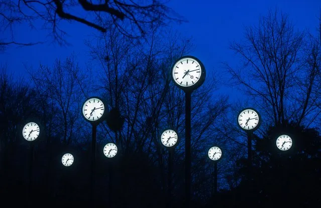 Clocks of the art installation “Zeitfeld” (time field) by German artist Klaus Rinke are seen in Duesseldorf, western Germany, on March 23, 2021. Clocks in Germany will be changed to summer time and set back by one hour on Sunday, 28 March 2021. (Photo by Ina Fassbender/AFP Photo)