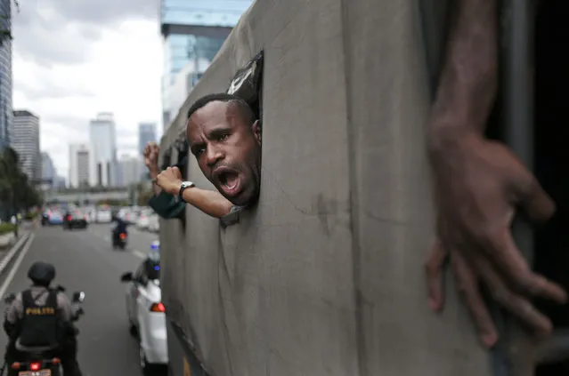 A West Papuan protester shouts slogans as he and others are taken away on a police truck during a rally calling for the remote region's independence, in Jakarta, Indonesia, Thursday, December 1, 2016. (Photo by Dita Alangkara/AP Photo)