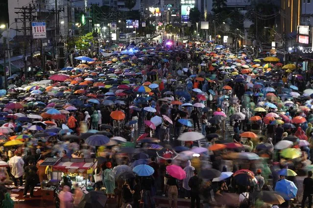 Supporters of the Move Forward Party walk in a circle during a protest in Bangkok, Thailand, Sunday, July 23, 2023. The demonstrators are protesting that Thailand's Constitution is undemocratic, because it allowed Parliament to block the winner of May's general election, the Move Forward Party, from naming its leader named the new prime minister, even though he had assembled an eight-part coalition that had won a clear majority of seats in the House of Representatives. (Photo by Sakchai Lalit/AP Photo)